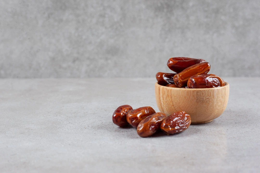 small-bowl-dates-handful-marble-background